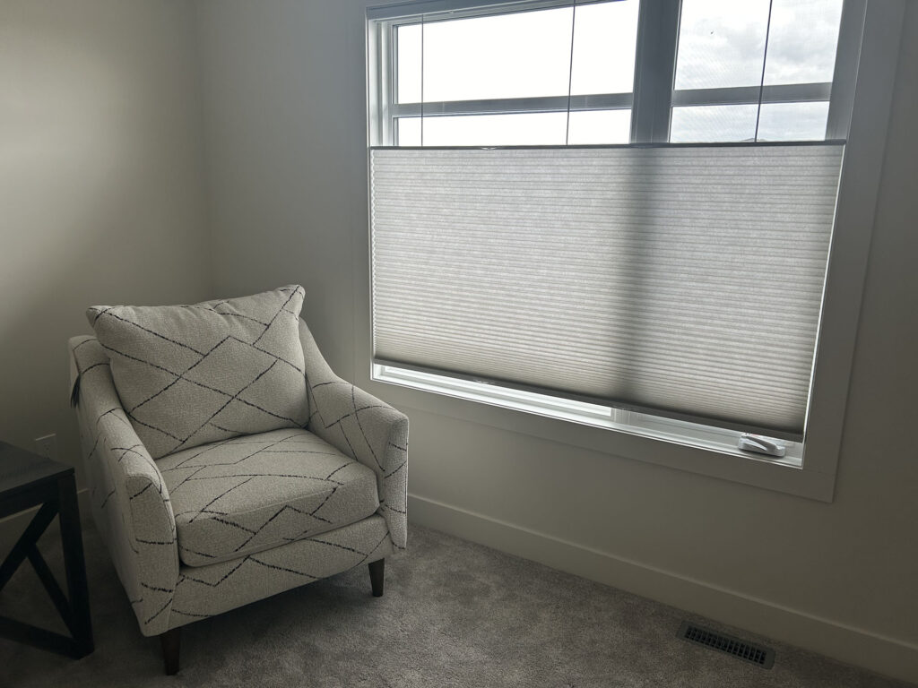 Armchair Beside Window with Light-Filtering Cellular Shade