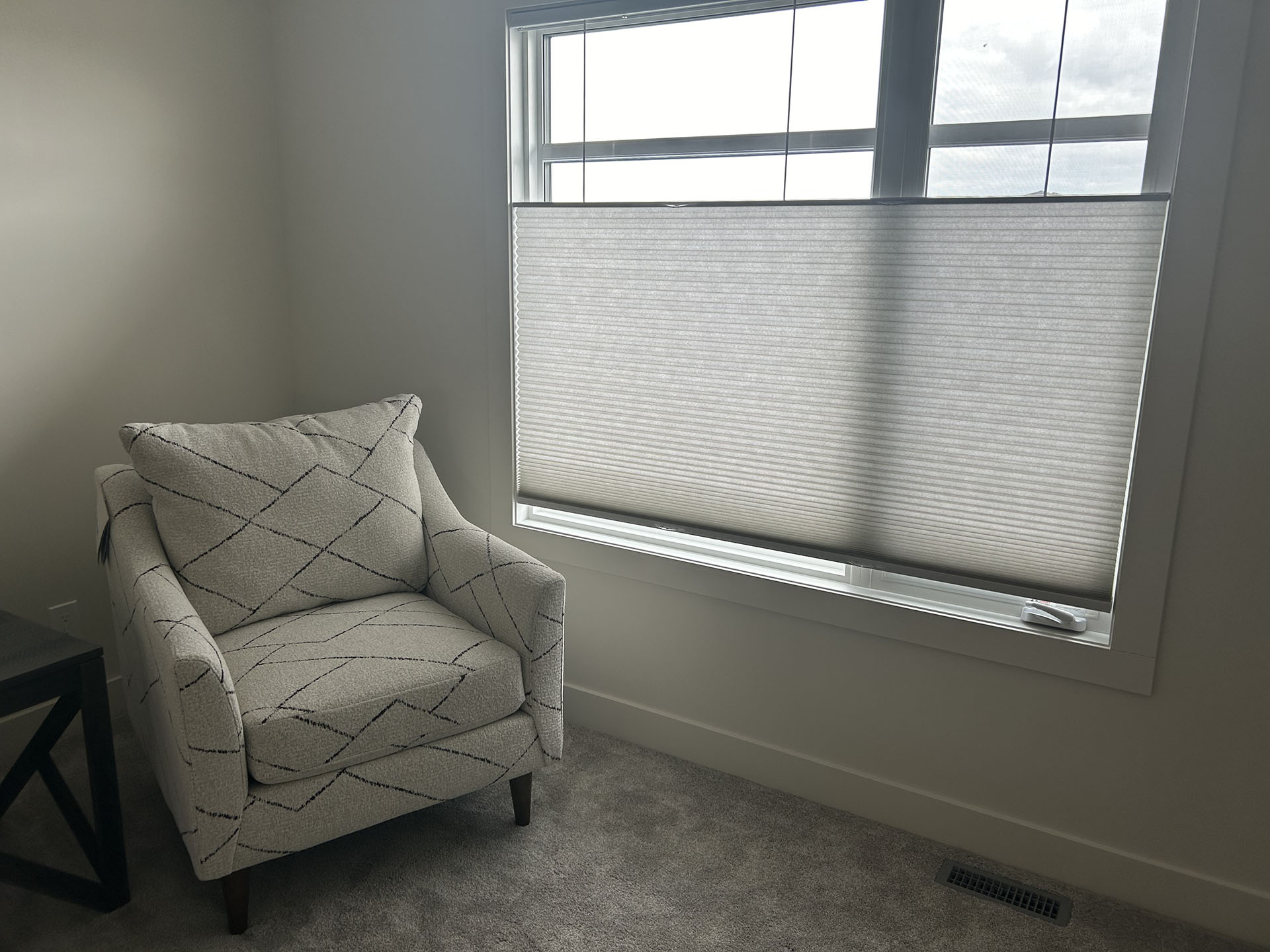 Armchair Beside Window with Light-Filtering Cellular Shade