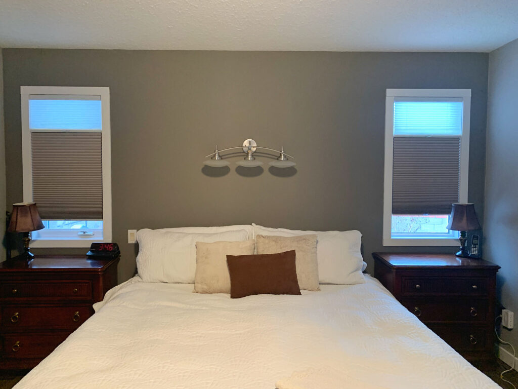 Bedroom Setup with Symmetrical Cellular Shades Flanking Bed