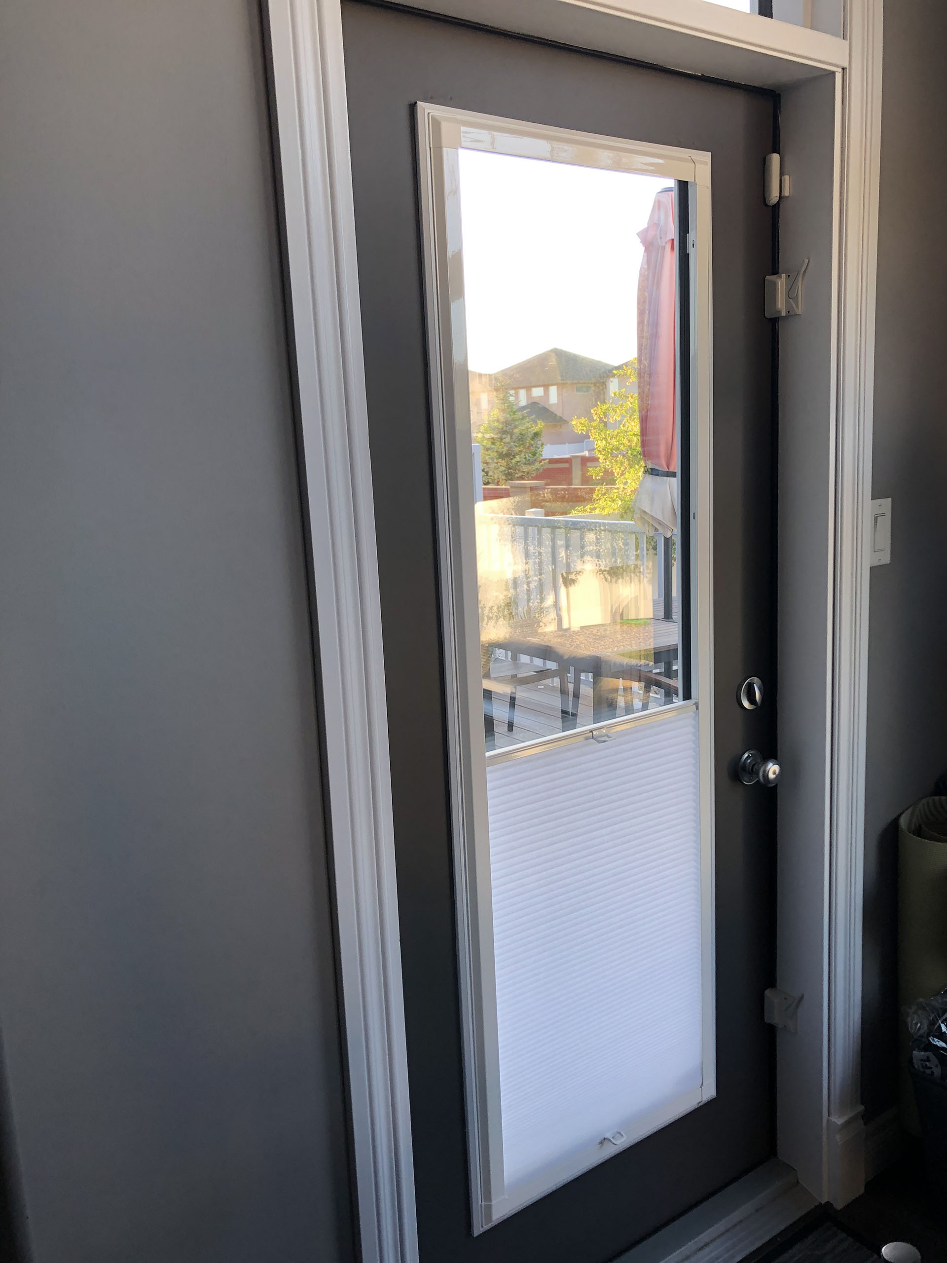 Dark Exterior Door with Top-Down Cellular Shade Trimmed Window