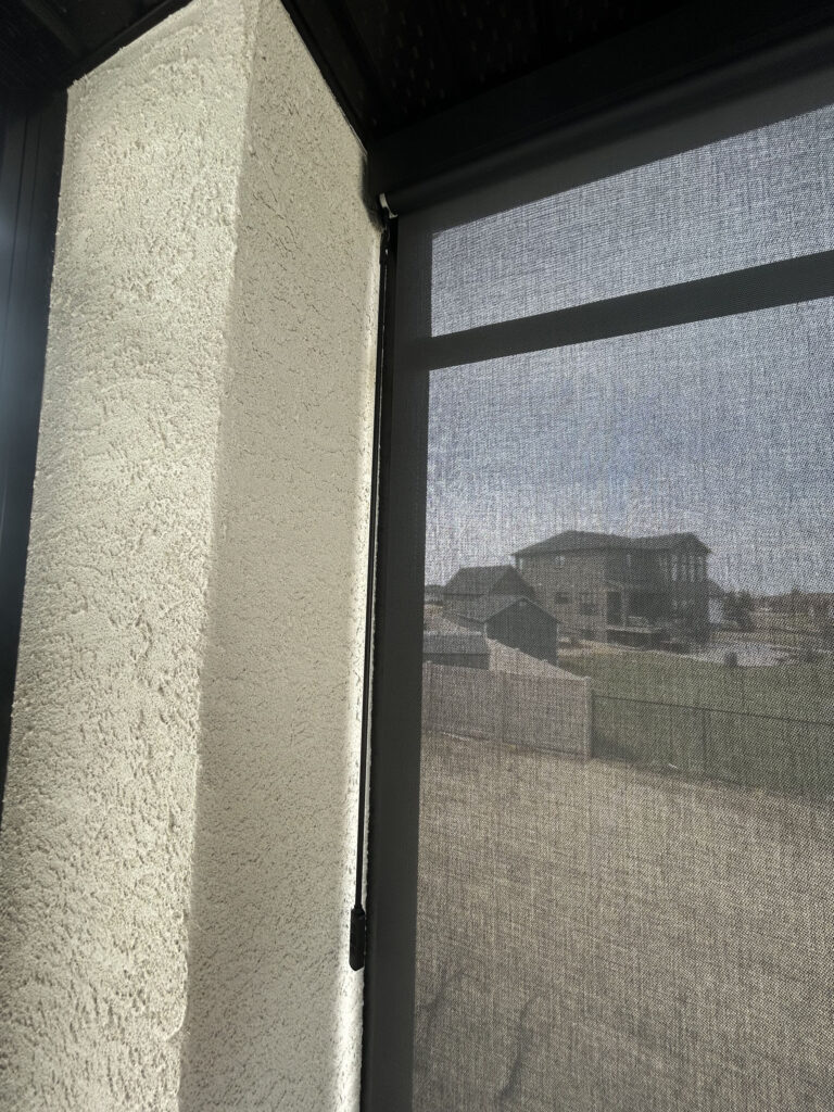 Detail View of Solar Shade Track Mounted to Stucco Pillar