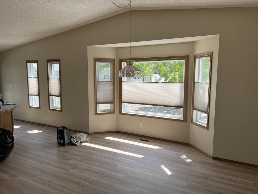 Dining Area Renovation Featuring Bay Window Shades and Vintage Pendant Light
