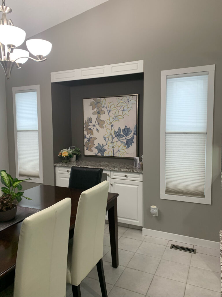 Dining Room Wall Accent with Symmetrical Window Shades and Buffet Counter