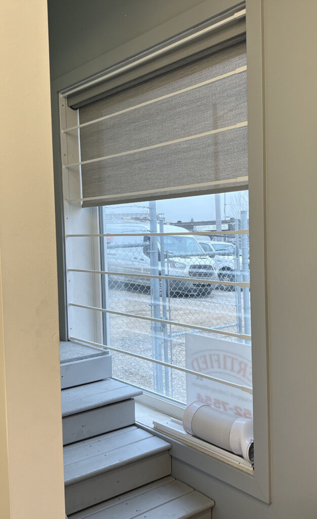Entryway Window with Roller Shade Behind Security Bars