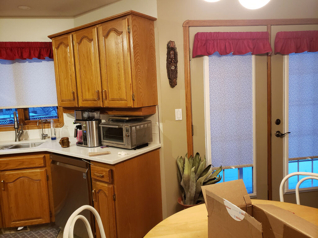 Kitchen French Doors with Patterned Cellular Shades and Red Valances
