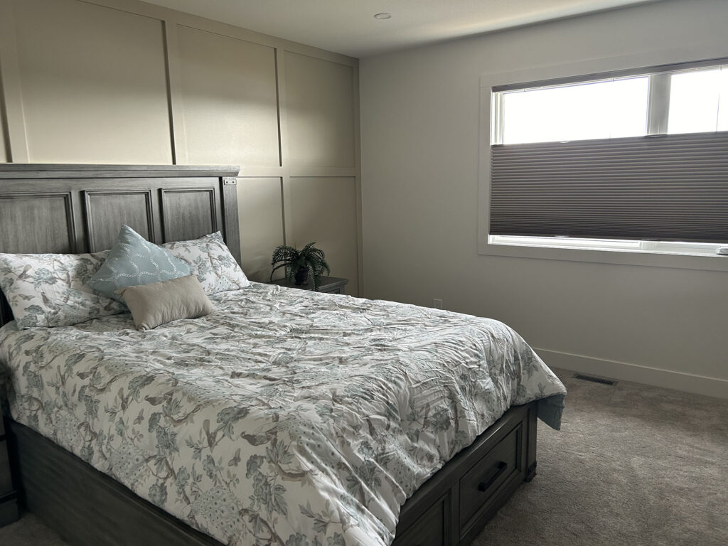 Master Bedroom Bed Facing Window with Dark Cellular Shade