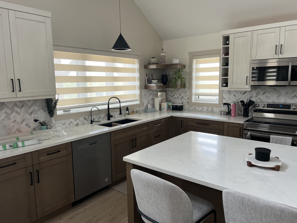 Modern Kitchen Featuring Zebra Blinds and Marble Backsplash