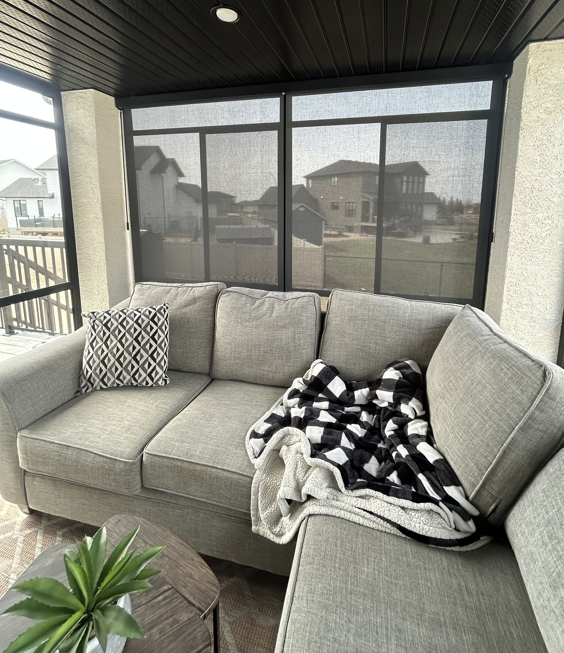 Sunroom Seating Area with Sectional Couch and Outdoor Solar Shades