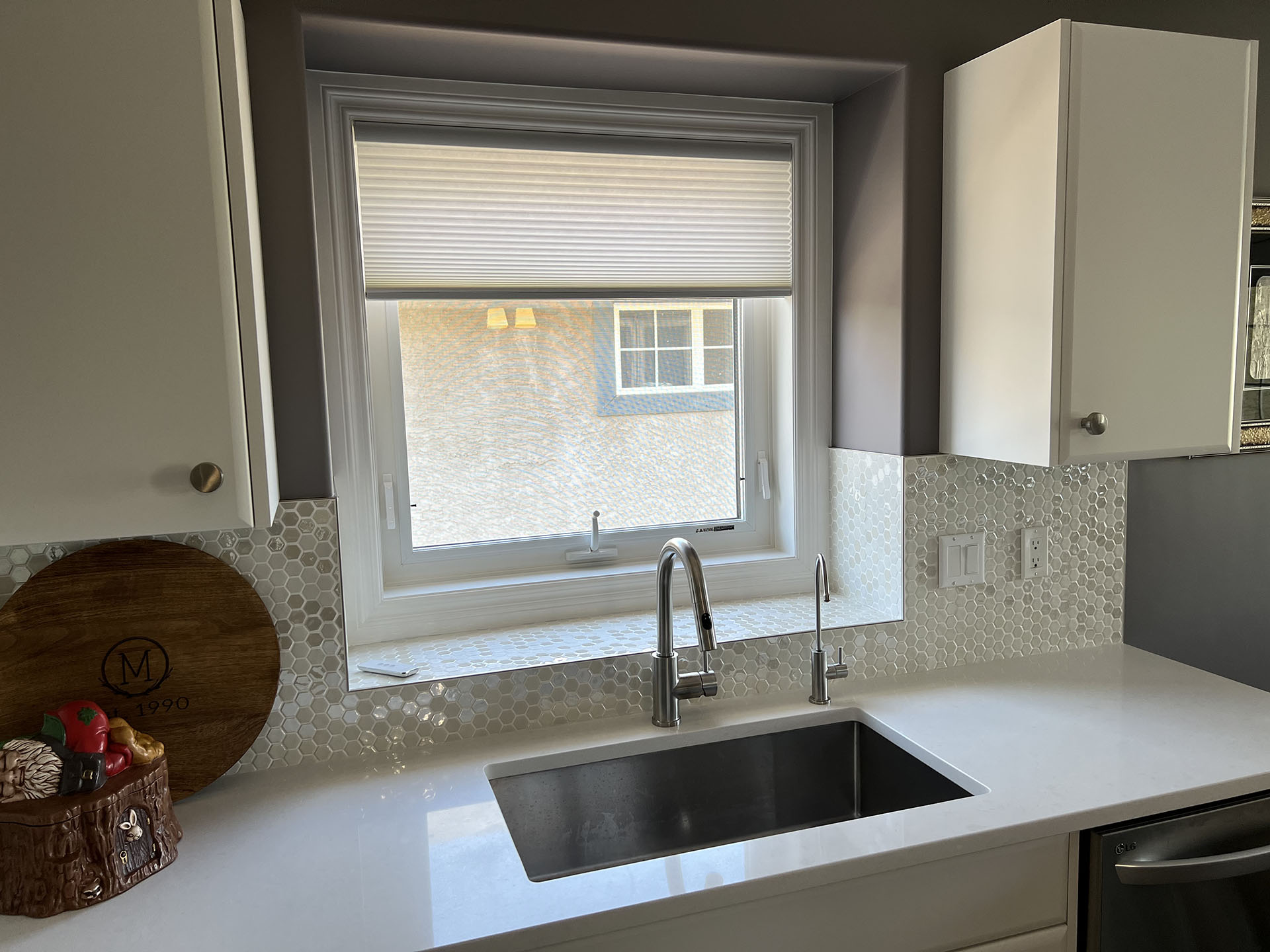 White Cellular Shade Over Kitchen Sink with Tile Backsplash